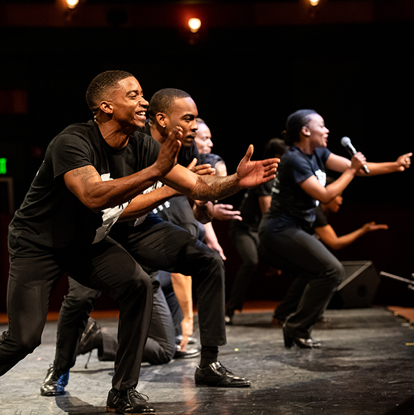 Students dancing on stage in the PAC for Black History Month